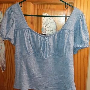 A blue crop top with fluffy sleeves